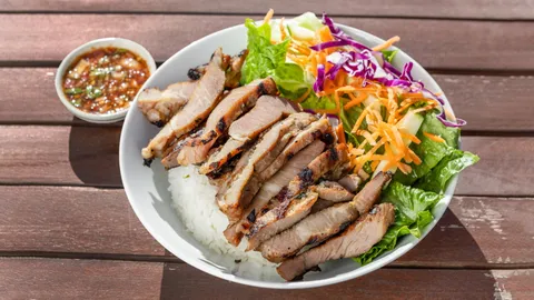 Moo Ping bowl with jasmine rice, fresh salad, and dipping sauce